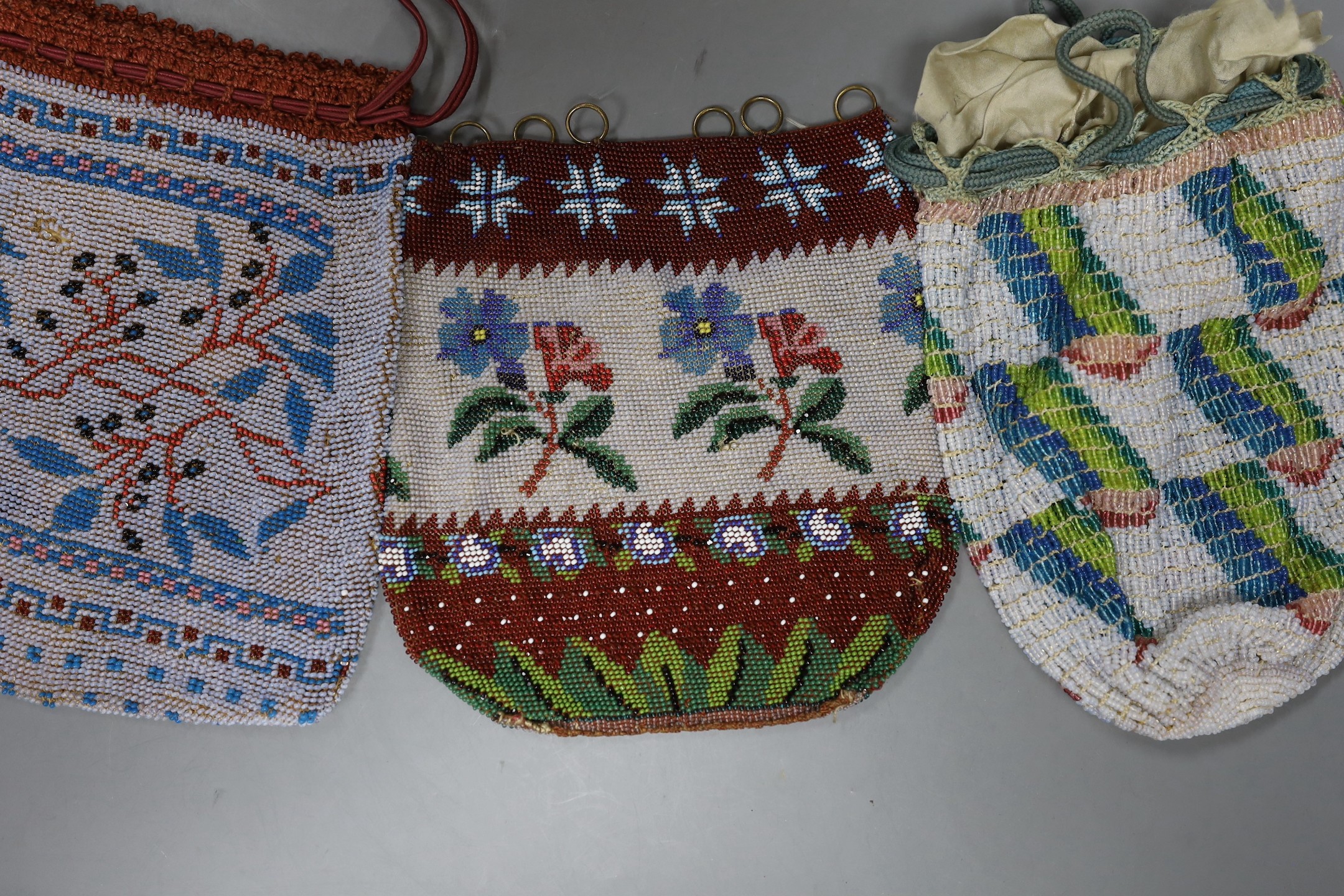 A 19th century bead worked bag with sailing ship design, a similar floral bead worked bag and a 1920’s-30’s abstract bead worked bag